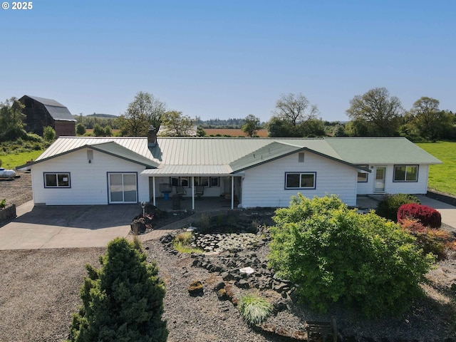 41108/41100 Oupor Dr, Scio, OR 97374 - ranch-style home featuring metal roof, a chimney, driveway, and a patio
