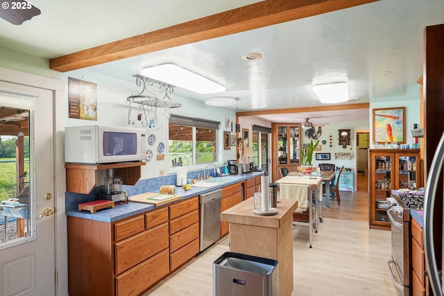 41108/41100 Oupor Dr, Scio, OR 97374 - kitchen with appliances with stainless steel finishes, a sink, light wood-style flooring, brown cabinetry, and beamed ceiling