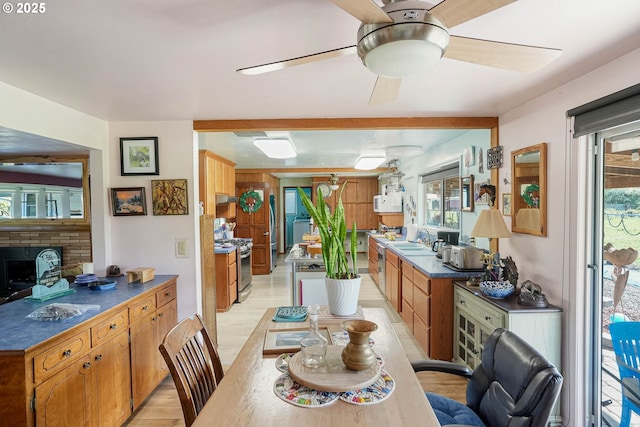 41108/41100 Oupor Dr, Scio, OR 97374 - kitchen featuring light wood finished floors, gas stove, ceiling fan, a sink, and brown cabinets