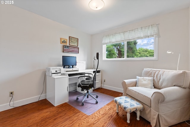 office area with baseboards and wood finished floors