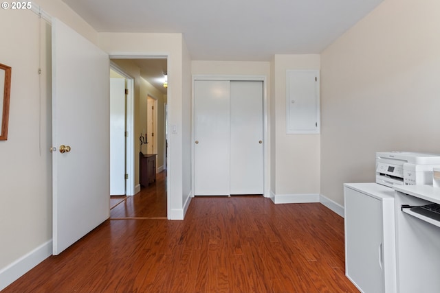 interior space featuring light countertops, baseboards, and wood finished floors