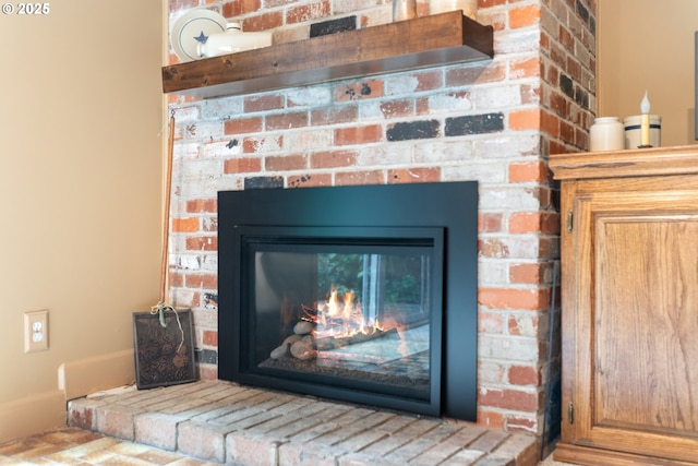 details featuring a brick fireplace