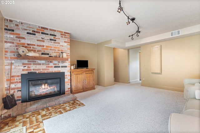 unfurnished living room with visible vents, baseboards, carpet floors, and a fireplace
