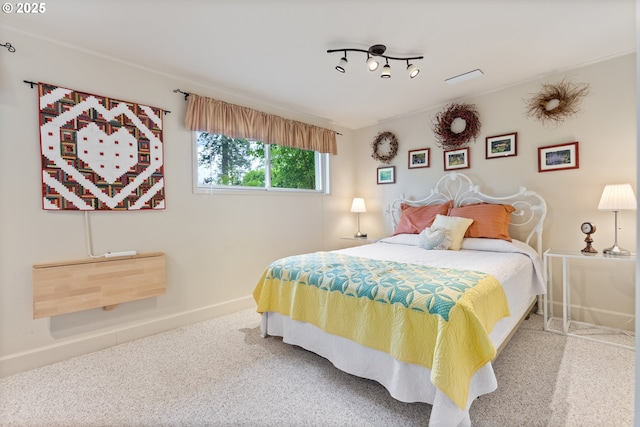 bedroom featuring baseboards and carpet