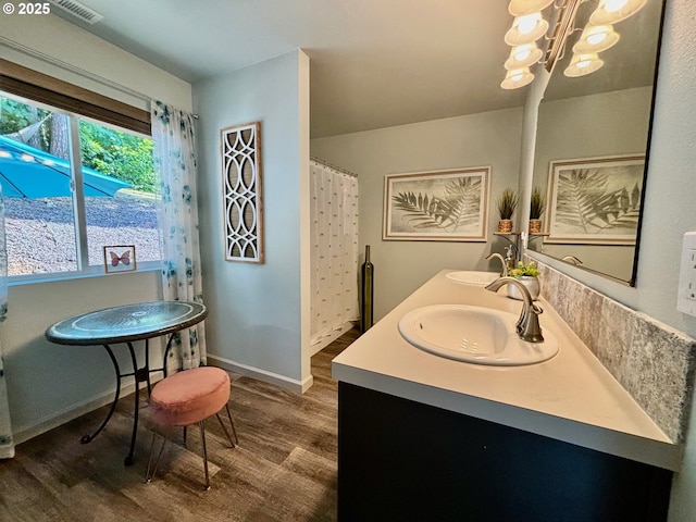 6189 Forest Ridge Dr, Springfield, OR 97478 - full bathroom featuring wood finished floors, a chandelier, and double vanity