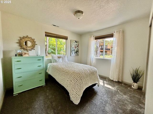 6189 Forest Ridge Dr, Springfield, OR 97478 - bedroom with dark carpet, multiple windows, and a textured ceiling