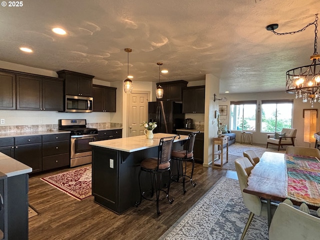 6189 Forest Ridge Dr, Springfield, OR 97478 - kitchen featuring stainless steel appliances, open floor plan, a chandelier, light countertops, and recessed lighting