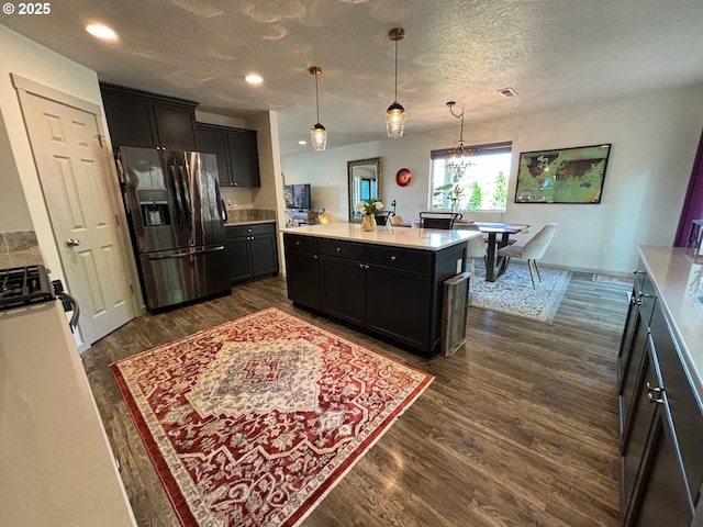 6189 Forest Ridge Dr, Springfield, OR 97478 - kitchen with stainless steel fridge, stove, dark wood-style flooring, a textured ceiling, and light countertops