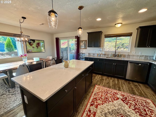 6189 Forest Ridge Dr, Springfield, OR 97478 - kitchen featuring dishwasher, dark wood finished floors, a textured ceiling, healthy amount of natural light, and a kitchen island