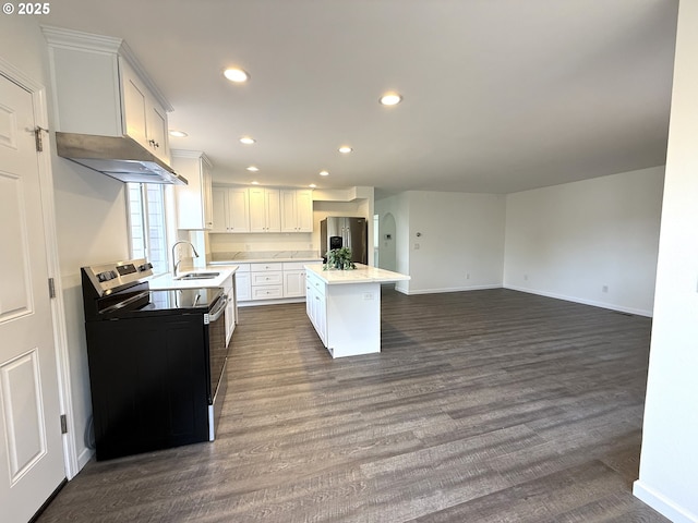 kitchen with white cabinetry, electric range oven, stainless steel fridge, and a center island