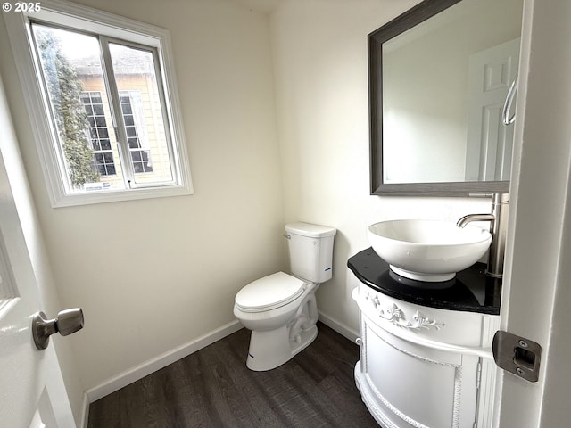 bathroom with vanity, wood-type flooring, and toilet