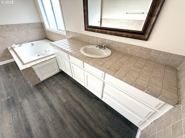 bathroom featuring vanity, wood-type flooring, and a bathing tub