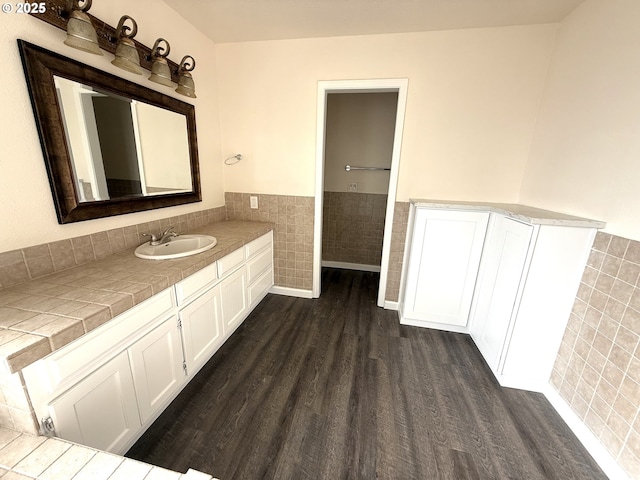 bathroom with tile walls, vanity, and wood-type flooring