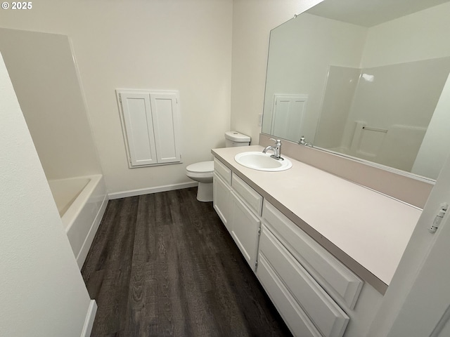 full bathroom with vanity, wood-type flooring,  shower combination, and toilet