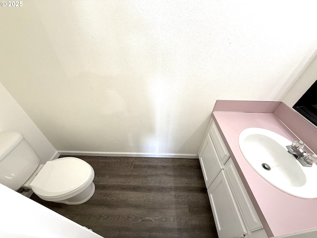 bathroom featuring vanity, toilet, and hardwood / wood-style floors