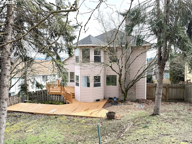 rear view of house featuring a deck