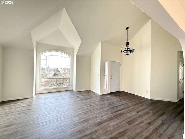 interior space featuring an inviting chandelier, dark hardwood / wood-style flooring, and high vaulted ceiling