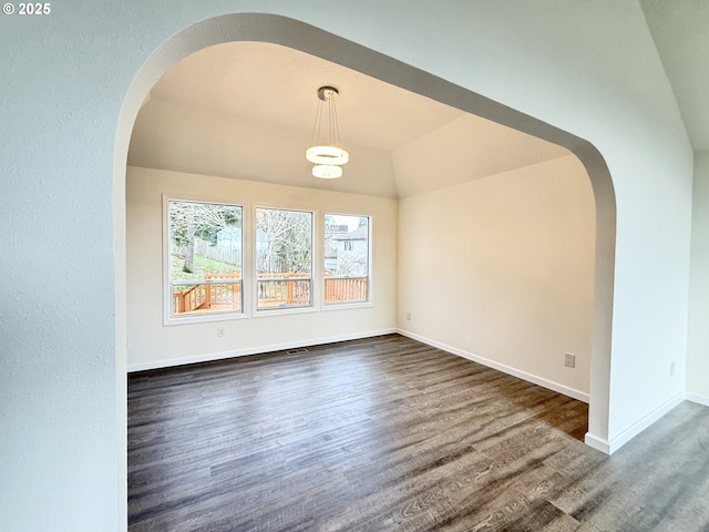 interior space featuring lofted ceiling and dark hardwood / wood-style flooring