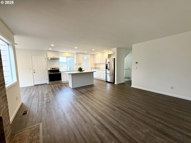 unfurnished living room featuring dark wood-type flooring