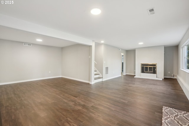 unfurnished living room with dark hardwood / wood-style floors