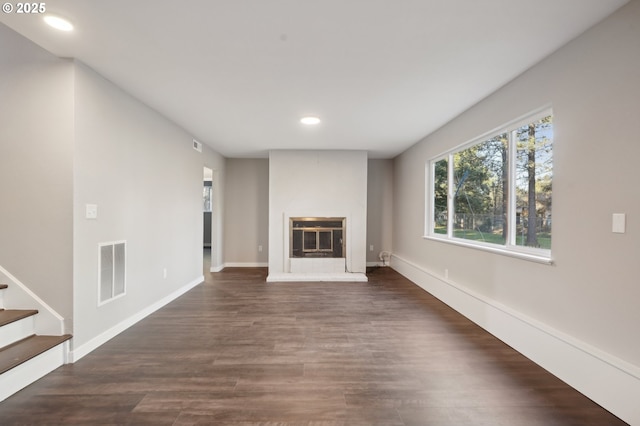 unfurnished living room with dark hardwood / wood-style floors