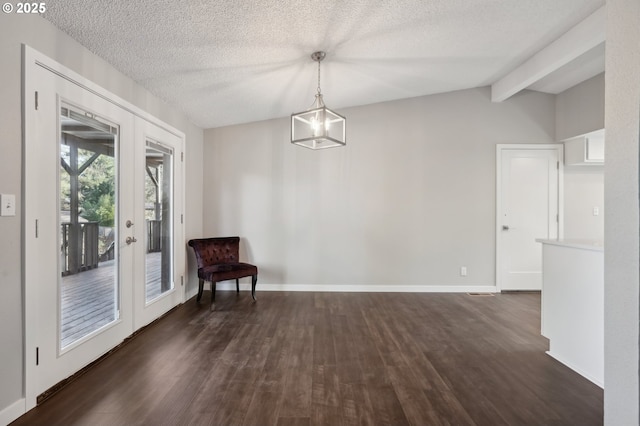 interior space featuring an inviting chandelier, vaulted ceiling with beams, dark wood-type flooring, a textured ceiling, and french doors