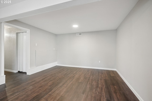 spare room with dark wood-type flooring