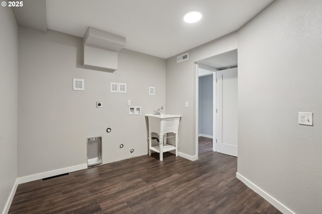 clothes washing area with gas dryer hookup, washer hookup, hookup for an electric dryer, and dark hardwood / wood-style flooring