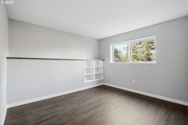 spare room featuring dark hardwood / wood-style flooring