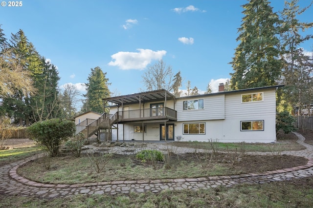 back of house featuring a wooden deck