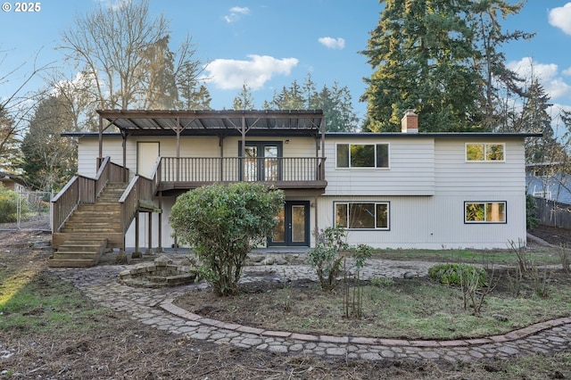 back of house with french doors and a deck