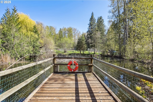 wooden terrace featuring a water view