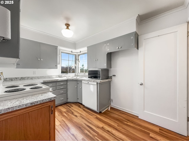 kitchen featuring ornamental molding, white appliances, and gray cabinetry