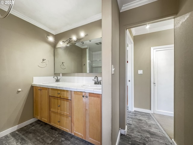 full bath featuring ornamental molding, visible vents, a sink, and double vanity