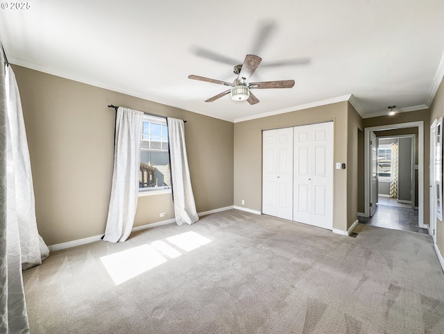 unfurnished bedroom featuring carpet floors, baseboards, a closet, and ornamental molding