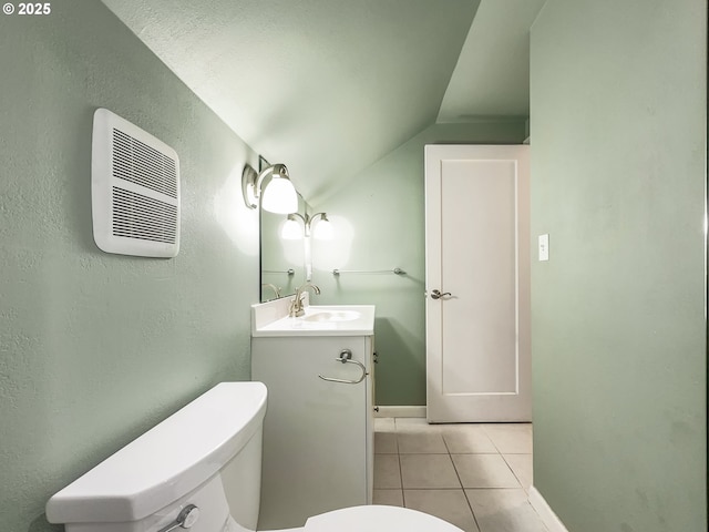 half bathroom with toilet, vanity, vaulted ceiling, and tile patterned floors