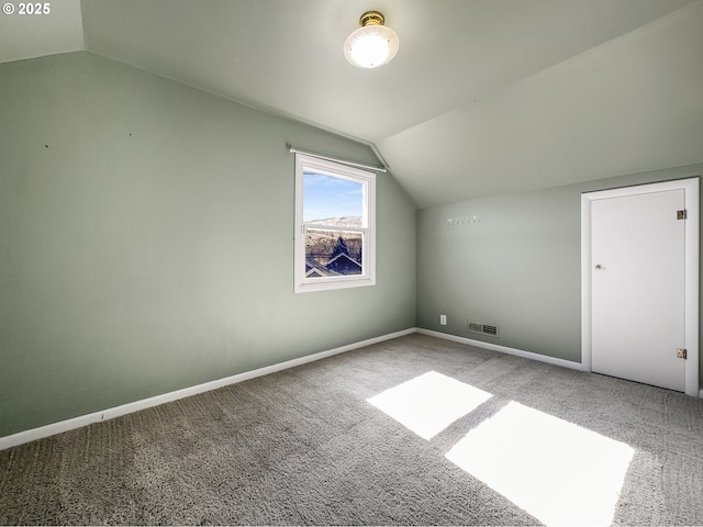 bonus room featuring carpet floors, lofted ceiling, visible vents, and baseboards