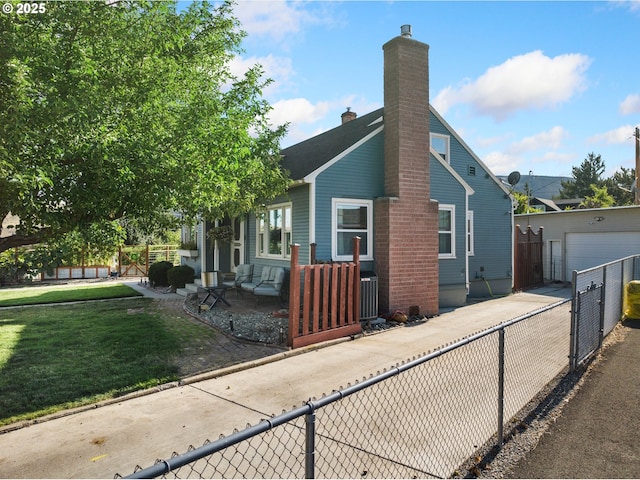 view of front of property with a front lawn, fence, a chimney, and an outdoor structure