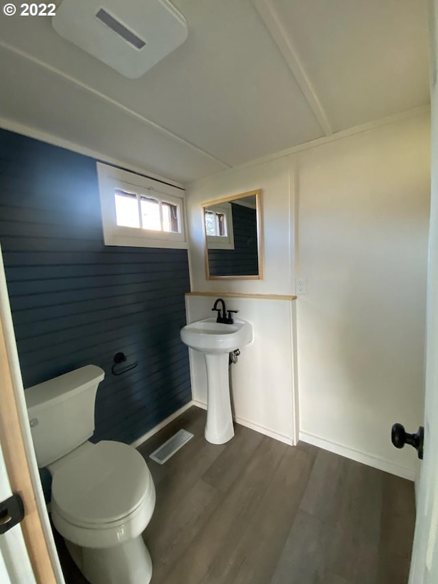 bathroom with visible vents, wood finished floors, toilet, and baseboards