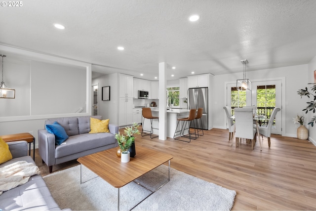 18478 Rose Ct, West Linn, OR 97068 - living room with a textured ceiling, light wood finished floors, and recessed lighting