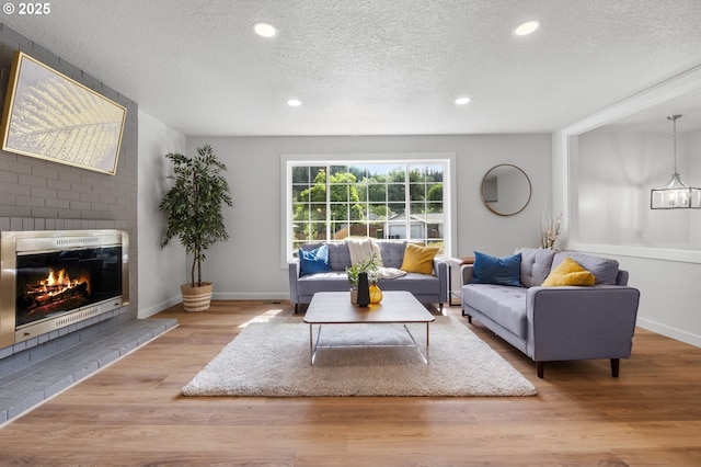 18478 Rose Ct, West Linn, OR 97068 - living room with a textured ceiling, a brick fireplace, wood finished floors, recessed lighting, and heating unit