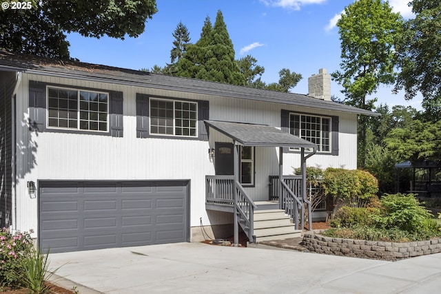 18478 Rose Ct, West Linn, OR 97068 - split foyer home featuring a chimney, a garage, driveway, and roof with shingles