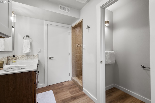 18478 Rose Ct, West Linn, OR 97068 - bathroom with double vanity, a shower stall, and wood finished floors