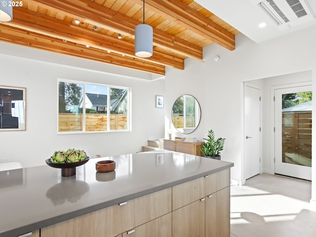 kitchen with pendant lighting, wood ceiling, beamed ceiling, and light brown cabinets