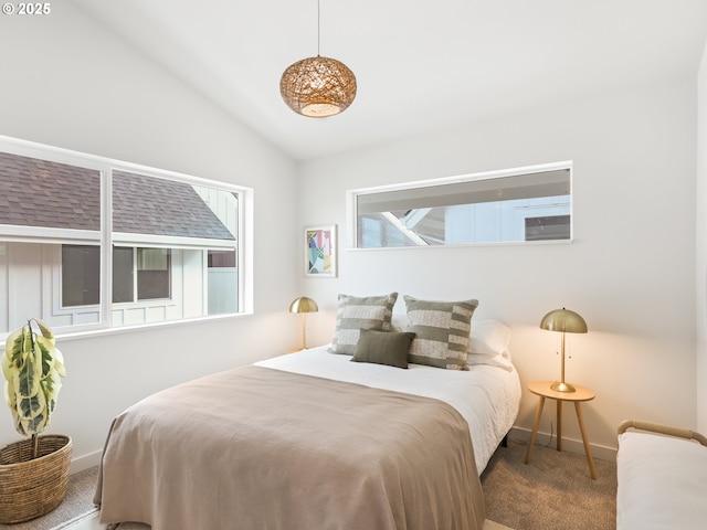 bedroom featuring lofted ceiling and carpet