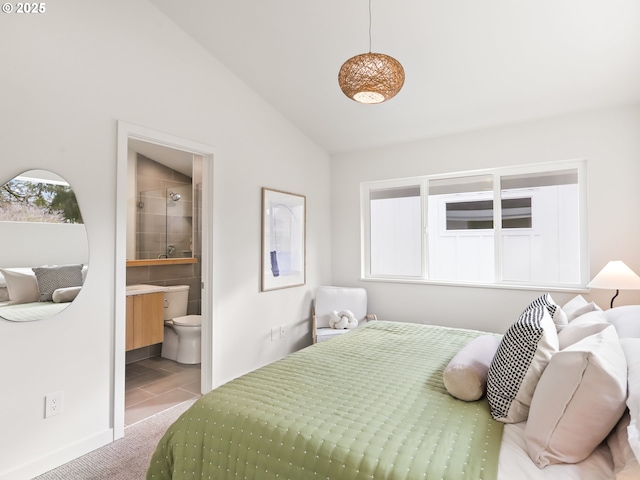 carpeted bedroom with lofted ceiling and ensuite bathroom