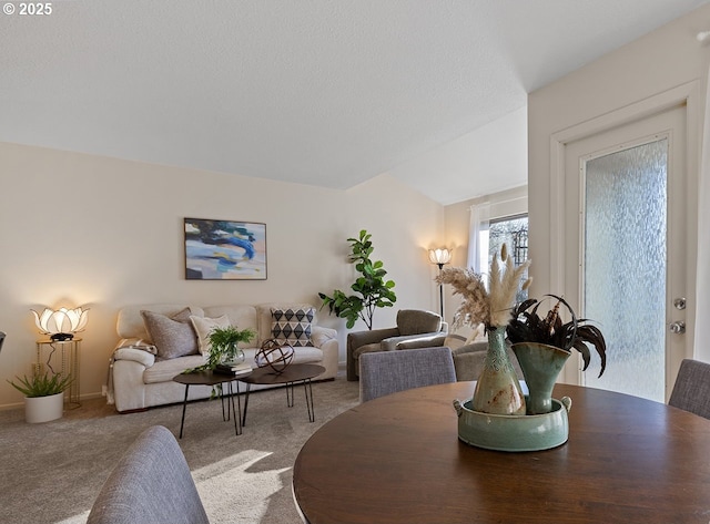 dining space featuring carpet floors and a textured ceiling