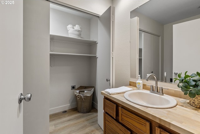 bathroom with vanity and wood-type flooring