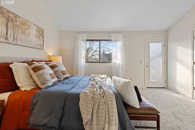 carpeted bedroom with access to outside and vaulted ceiling