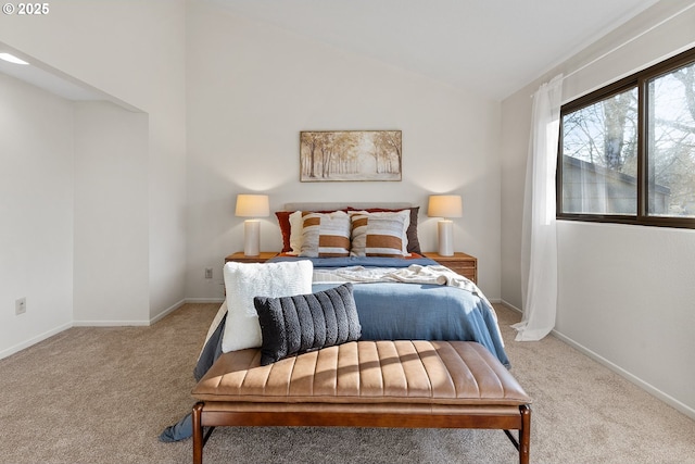 bedroom featuring vaulted ceiling and light colored carpet